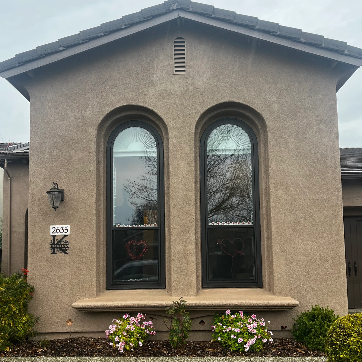 Twin arched specialty windows on stucco wall