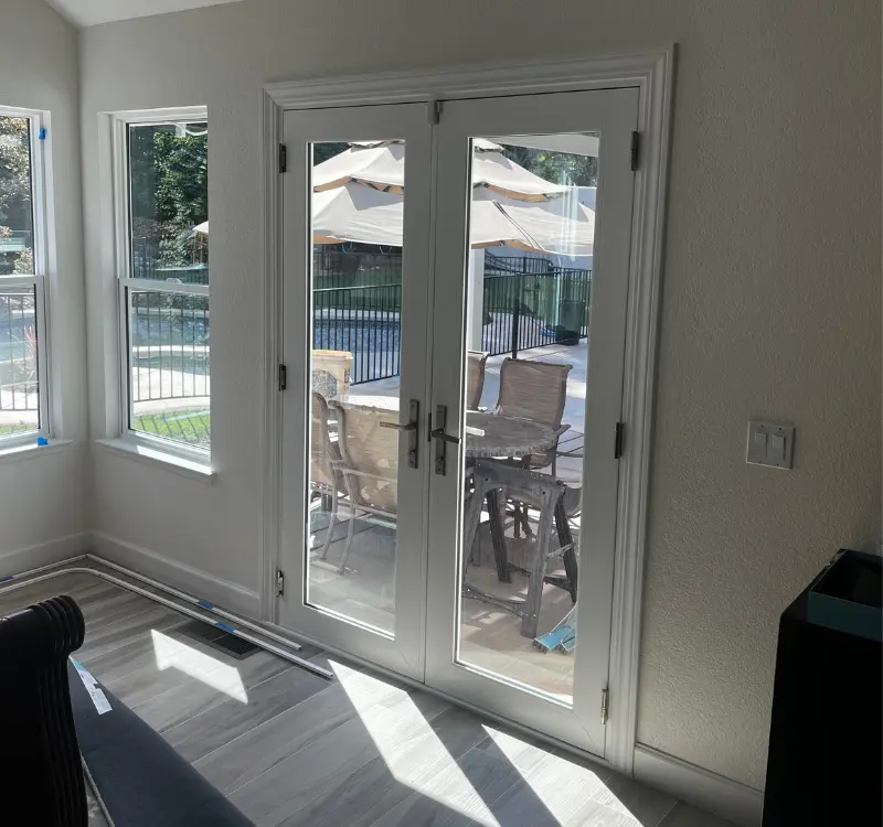 White double French doors leading to patio after professional door installation Sacramento
