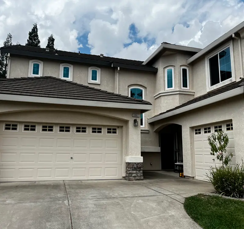 Two-story home in Sacramento with custom white-frame vinyl window installations by Clear View